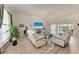 Spacious living room with vaulted ceilings, modern furniture, and a view of the outdoor pool area at 221 Fairway Rd, Rotonda West, FL 33947