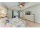 Serene main bedroom with tray ceilings, a decorative ceiling fan, and lanai access at 221 Fairway Rd, Rotonda West, FL 33947