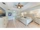 Serene main bedroom with tray ceilings, a decorative ceiling fan, and an en-suite bathroom at 221 Fairway Rd, Rotonda West, FL 33947