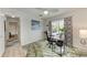 Inviting office space with a modern desk, view of the screened in pool, and decorative palm themed rug at 221 Fairway Rd, Rotonda West, FL 33947