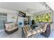 Cozy outdoor patio with comfortable seating, ceiling fan, and a view into the home at 221 Fairway Rd, Rotonda West, FL 33947