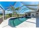 Enclosed pool with clear blue water, surrounded by lush tropical greenery at 221 Fairway Rd, Rotonda West, FL 33947