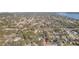 An aerial view shows mature trees and landscaping in the surrounding neighborhood, with a view of the bay in the distance at 2300 23Rd S St, St Petersburg, FL 33712