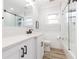 Clean bathroom featuring quartz counters, glass shower doors, and wood look tile floors at 2300 23Rd S St, St Petersburg, FL 33712