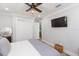 Bedroom with ceiling fan, closet, mounted TV, and view to the hallway at 2300 23Rd S St, St Petersburg, FL 33712