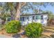 Charming one-story home with a well-maintained lawn, landscaped bushes, and mature trees at 2300 23Rd S St, St Petersburg, FL 33712