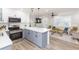 Open kitchen and living room area with stainless steel appliances and a center island with quartz countertop at 2300 23Rd S St, St Petersburg, FL 33712