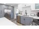 Modern kitchen with stainless steel appliances, grey and white cabinets, and a view to the exterior at 2300 23Rd S St, St Petersburg, FL 33712