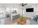 Open-concept living room and kitchen area with modern decor and stylish light fixtures at 2300 23Rd S St, St Petersburg, FL 33712