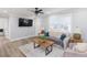 Bright living room with a comfortable seating area, light wood floors, and a modern ceiling fan at 2300 23Rd S St, St Petersburg, FL 33712