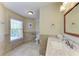 Bright bathroom with large window, neutral tile, and modern fixtures at 2306 Canasta Dr, Bradenton Beach, FL 34217