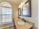 Double-sink bathroom with granite countertops, tiled floors and backsplash at 2306 Canasta Dr, Bradenton Beach, FL 34217