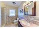 Bathroom with tiled walls, decorative mirror, walk-in shower, and granite countertop at 2306 Canasta Dr, Bradenton Beach, FL 34217