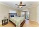 Cozy bedroom with wood floors, ceiling fan, and private balcony overlooking the water at 2306 Canasta Dr, Bradenton Beach, FL 34217