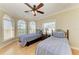 Bedroom featuring two twin beds, hardwood floors, ceiling fan and bay windows at 2306 Canasta Dr, Bradenton Beach, FL 34217