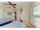 Inviting bedroom with two twin beds, hardwood floors, ceiling fan and exterior door at 2306 Canasta Dr, Bradenton Beach, FL 34217