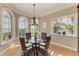 Charming dining area with natural light, modern chandelier, hardwood floors, and seating for four at 2306 Canasta Dr, Bradenton Beach, FL 34217