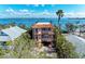 Elegant three-story waterfront home with multiple balconies and a tile roof at 2306 Canasta Dr, Bradenton Beach, FL 34217