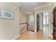 Hallway with hardwood floors, arched window, and decorative door leading to a bedroom at 2306 Canasta Dr, Bradenton Beach, FL 34217