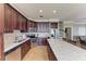 Spacious kitchen with granite countertops, stainless steel appliances, dark wood cabinets, and center island with breakfast bar at 2306 Canasta Dr, Bradenton Beach, FL 34217