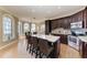 Bright kitchen boasts granite countertops, an island with seating, stainless steel appliances, and a breakfast nook with scenic views at 2306 Canasta Dr, Bradenton Beach, FL 34217