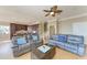 Inviting living room with hardwood floors, ceiling fan, and comfortable seating adjacent to a large kitchen at 2306 Canasta Dr, Bradenton Beach, FL 34217