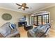 Inviting living room with hardwood floors, neutral tones, and French doors to the outdoors at 2306 Canasta Dr, Bradenton Beach, FL 34217