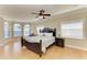 Spacious primary bedroom with hardwood floors, bay windows, and a ceiling fan at 2306 Canasta Dr, Bradenton Beach, FL 34217