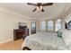 Inviting primary bedroom with hardwood floors, bay windows, ceiling fan and exterior door at 2306 Canasta Dr, Bradenton Beach, FL 34217