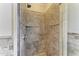 Modern tiled shower with glass door and rainfall showerhead at 2306 Canasta Dr, Bradenton Beach, FL 34217