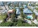 Aerial view of coastal homes featuring pools, docks, and lush greenery at 2308 Canasta Dr, Bradenton Beach, FL 34217
