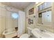 Charming bathroom featuring a clawfoot tub, unique window, and vintage-style sink at 2308 Canasta Dr, Bradenton Beach, FL 34217