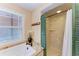 Charming bathroom showcasing a walk-in shower with a rainfall showerhead and natural light from the window at 2308 Canasta Dr, Bradenton Beach, FL 34217