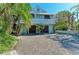 Charming home with a metal roof, beautiful landscaping, and a spacious driveway at 2308 Canasta Dr, Bradenton Beach, FL 34217