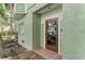 Welcoming front entry featuring tile, wood accents, and a glass-paneled door at 2308 Canasta Dr, Bradenton Beach, FL 34217