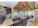 Open-concept kitchen boasts rustic wood ceiling beams, a spiral staircase, and seamless living space at 2308 Canasta Dr, Bradenton Beach, FL 34217