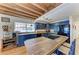 Well-lit kitchen with a wood island, wood ceiling beams, and rustic blue cabinetry at 2308 Canasta Dr, Bradenton Beach, FL 34217