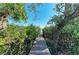 Charming private walkway through lush vegetation leading to the waterfront at 2308 Canasta Dr, Bradenton Beach, FL 34217