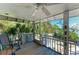 Relax in the screened porch with ceiling fan and scenic views of lush tropical trees and the bay at 2308 Canasta Dr, Bradenton Beach, FL 34217