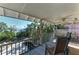 Inviting screened porch with ceiling fan overlooking lush greenery and the bay at 2308 Canasta Dr, Bradenton Beach, FL 34217