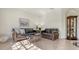 Well-lit living room with comfortable seating, tiled floors, and a decorative display cabinet at 2377 Burton Ln, Sarasota, FL 34239