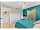 Inviting bedroom boasts neutral walls, tiled floors, and a decorative macrame wall hanging at 2431 Bayshore Gardens Pkwy # 19, Bradenton, FL 34207