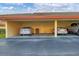 Three car carport showing a grill, cars, and other stored items at 2431 Bayshore Gardens Pkwy # 19, Bradenton, FL 34207