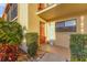 A welcoming front door with a cheerful sign, complemented by lush greenery and a cozy entrance area at 2431 Bayshore Gardens Pkwy # 19, Bradenton, FL 34207