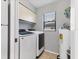Functional laundry room includes new washer and dryer with storage cabinets at 2431 Bayshore Gardens Pkwy # 19, Bradenton, FL 34207