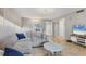 Cozy living room with modern decor, featuring a comfortable sofa, entertainment center, and tiled floors at 2431 Bayshore Gardens Pkwy # 19, Bradenton, FL 34207
