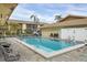 Community pool and surrounding deck with chairs and lush landscaping at 2431 Bayshore Gardens Pkwy # 19, Bradenton, FL 34207