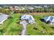 Aerial view of a modern home featuring meticulous landscaping and green lawn at 28960 Gin Ln, Punta Gorda, FL 33982