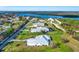 An aerial view showcasing homes in a waterside community with canals, docks, and boat lifts at 28960 Gin Ln, Punta Gorda, FL 33982