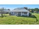 Rear exterior view showcasing the covered patio and expansive backyard at 28960 Gin Ln, Punta Gorda, FL 33982